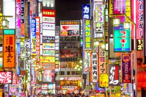 TOKYO, JAPAN - MARCH 14, 2014: Signs densely line an alleyway in Kabuki-cho. The area is a renown nightlife and red-light district.